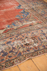 Antique Mahal carpet displaying even pile wear, madder red field, and blue and purple medallion elements.