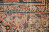 Antique Mahal carpet detail showing madder root red, faded purple, ivory motifs, worn pile.