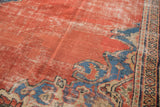Antique Persian Mahal carpet detail showing madder red field, sky blue spandrel, textured pile.