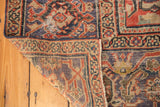 Mahal carpet corner folded back, revealing secured side, foundation, and pile wear.