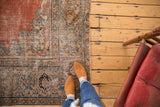 Hand-knotted antique Mahal carpet's corner spandrel with madder red field and sky blue border wear.
