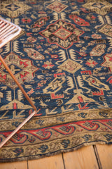 Antique Caucasian rug detail, early 20th century, geometric motifs in navy, red, ivory.