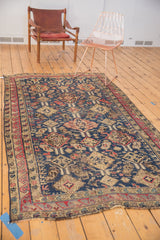 Antique Soumac rug's hand woven secured end featuring a navy and red geometric border.