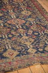 Antique Caucasian Soumac carpet with navy, red, ivory blossoming plant design.