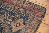Antique Caucasian Soumac flatweave corner, with geometric navy, cherry red, and ivory patterns.