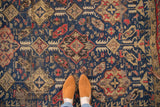 Antique Caucasian Soumac rug's allover navy blue, cherry red, and ivory geometric design.
