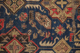 Close-up of the antique Caucasian Soumac carpet's hand woven texture and geometric pattern.