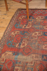 Oversize madder red and sky blue guls with visible wear on a vintage Afghan carpet.
