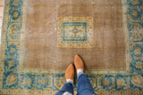 Distressed vintage Agra rug with square medallion, wide serrated leaf border, coffee brown and sky blue.