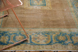 Distressed vintage Agra rug corner, pale coffee bronze field, sky blue serrated leaf border.