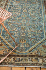 Distressed Hamadan runner's faded Herati pattern in sky blue, saffron, and brown.