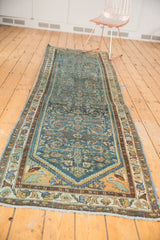 Distressed Persian Hamadan runner featuring herati design in muted blue, brown, and gold tones.