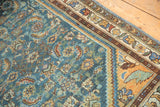 Saffron yellow corner spandrel with simplistic leaf, meandering floral border, distressed blue field.