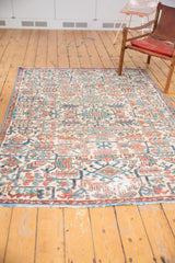 Distressed vintage Heriz allover pattern in ivory, sky blue, and faded brick red.