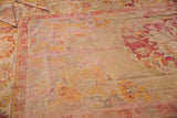 Fragmented vintage Turkish Oushak rug with a professional seam, worn pile, and faded gold, red designs.