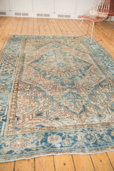 Distressed vintage Heriz border with blue and camel geometric patterns and secure fringe.