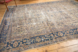Vintage Sparta carpet's navy blue floral border against a distressed ivory field.
