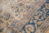 Navy blue and antique ivory floral tendril pattern on distressed vintage Sparta carpet.