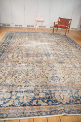 Vintage distressed Sparta carpet displaying faded classic floral and tendril patterns.