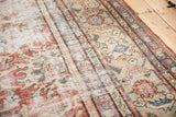 Distressed texture of antique Mahal rug, showing low pile, visible foundation, faded madder red.