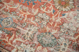 Distressed antique Mahal carpet texture, showing madder red, sand, and sky blue floral palmettes.