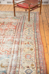 Worn madder red field and intricate sky blue and sand borders of an antique distressed Mahal rug.