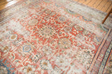 Distressed Mahal carpet corner showcasing madder red field, faded floral palmettes, and textured wear.