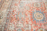 Distressed Mahal carpet close-up, showing madder red, sky blue palmettes, and aged texture.