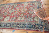 Distressed ruby red Mahal carpet with worn pile and detailed ivory, teal patterns.