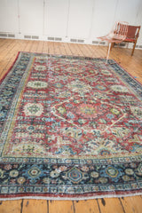 Distressed Mahal carpet border, featuring dusty navy teal, ruby red, and visible foundation wear.