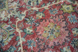 Worn texture of a vintage distressed Mahal carpet, with ruby red, blue, and sand floral motifs.