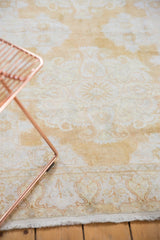 Lower edge of distressed vintage cotton Kayseri rug, showing ivory and pale gold paisley motifs.