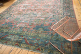 Faded cranberry, dusty teal vinery, and worn areas on a distressed Mahal rug.