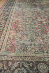 Vintage Distressed Mahal carpet's worn pile, showcasing faded blush, green, and ivory floral palmette details.