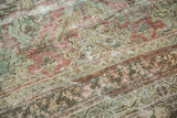 Distressed vintage Mahal carpet texture with muted blush, seafoam, ivory patterns and visible foundation wear.