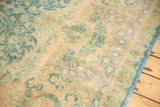 Khorassan carpet section: faded sky blue and camel scrolling islimis with visible wear.