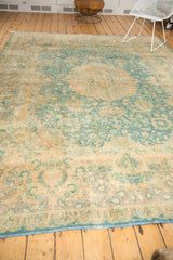 Ornate scrolling islimis, leaves, and palmette motifs in muted sky blue and camel gold.