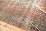 Distressed Antique Malayer rug runner with worn terra cotta field and sky blue patterned border.