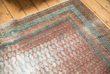 Distressed antique Malayer runner: worn terra cotta mir boteh design with blue border.
