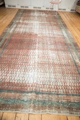 Distressed pile texture, white fringe, and blue border detail of the Malayer runner.