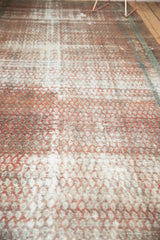Worn terra cotta Malayer rug showing distressed mir boteh pattern and visible foundation.