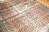 Antique Malayer rug runner's distressed terra cotta mir boteh pattern with visible white foundation.