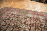 Worn herati motif, deep wine red, and charcoal brown on a distressed antique Karabagh.