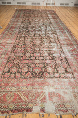 Distressed Karabagh runner showcasing an allover herati motif and extensive wear across dark brown field.