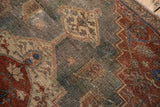Distressed Northwest Persian rug with faded geometric floral botehs and exposed knot heads.