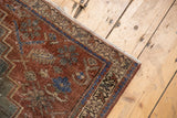 Distressed Northwest Persian rug, deep red field, blue geometric floral botehs, mostly even wear.