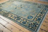 Distressed antique Peking rug border, indigo floral motifs, faint foundation.