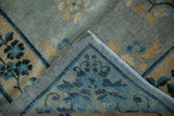 Distressed texture and hand-knotted foundation of an antique Chinese Peking rug, with blue and gold floral motifs.