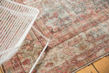 Textural close-up of distressed vintage Mahal runner, showcasing faded Herati design and foundation.