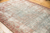 Distressed Mahal runner featuring faded ivory, pale blue, and blush floral motifs, foundation visible.